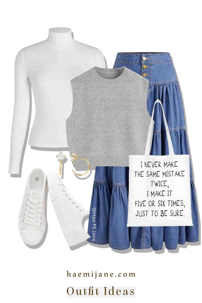 A flat lay fashion outfit featuring a white long-sleeve turtleneck, a grey knit sweater vest, a tiered denim maxi skirt with gold buttons, white canvas sneakers, and a white tote bag with black text